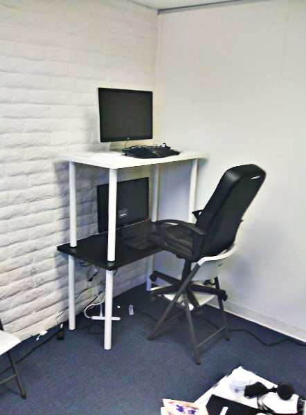 A desk on top of a desk, alongside a chair on top of a chair